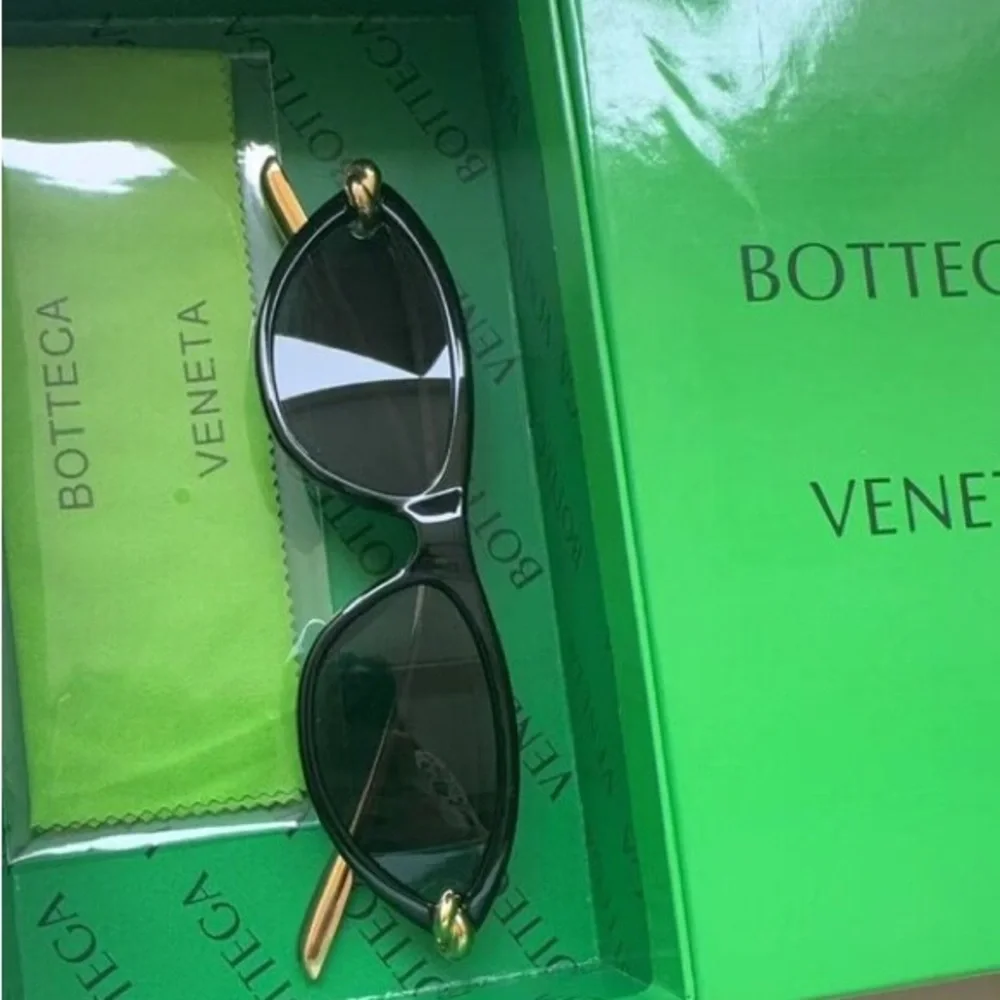 Bottega Veneta Black Frame Sunglasses with Amber Lenses and Gold Details